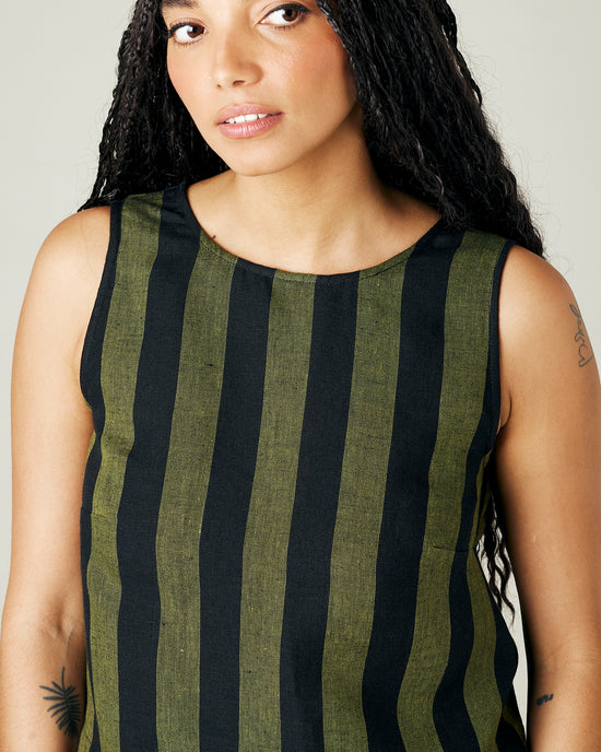 model wears olive and black stripe linen esme top