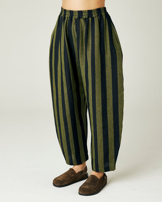 model wears olive and black stripe linen mabel trousers left side