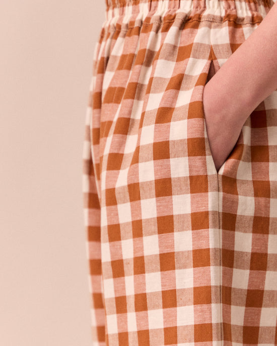 model wears mabel amber check linen trousers