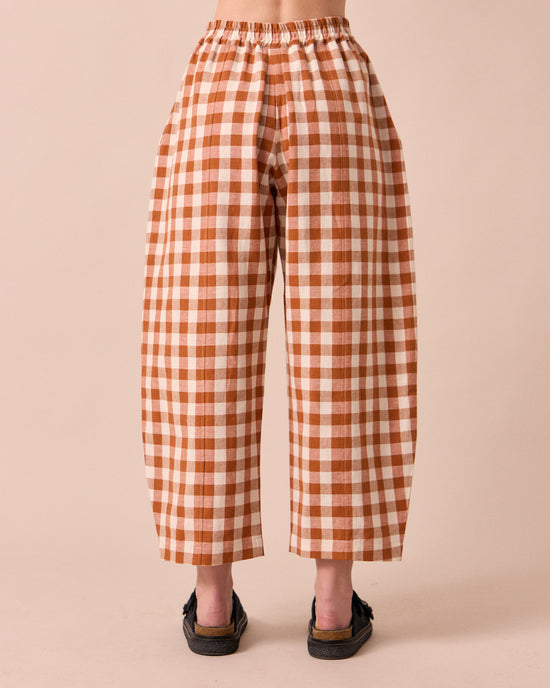 model wears mabel amber check linen trousers back