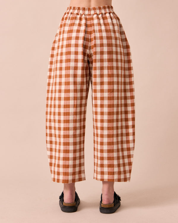 model wears mabel amber check linen trousers back