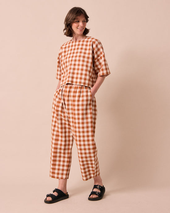 model wears mabel amber check linen trousers right