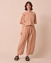 model wears mabel amber check linen trousers left