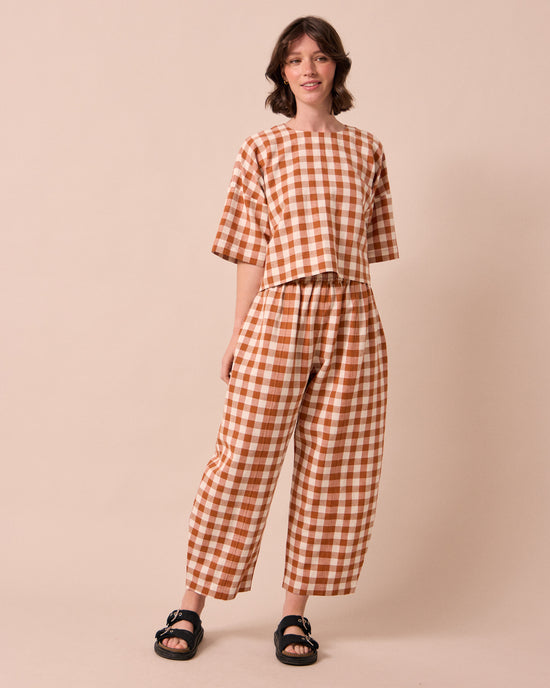model wears mabel amber check linen trousers left