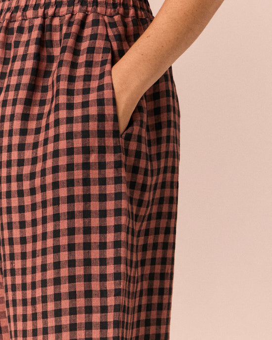 model wears mabel dried rose gingham linen trousers