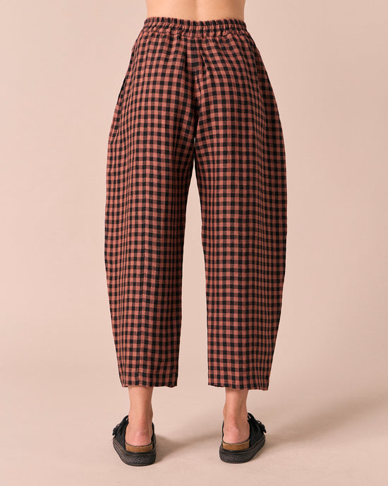 model wears mabel dried rose gingham linen trousers back