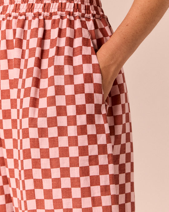 model wears mabel rosewood checkerboard linen trousers