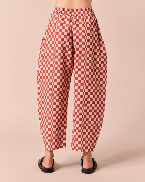 model wears mabel rosewood checkerboard linen trousers back
