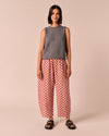model wears mabel rosewood checkerboard linen trousers right