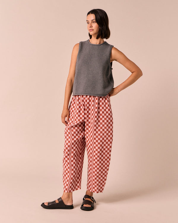 model wears mabel rosewood checkerboard linen trousers left
