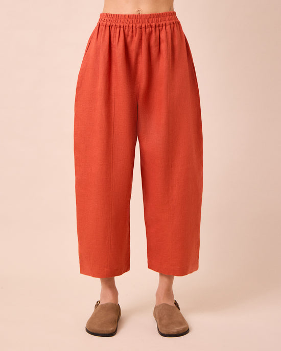 model wears mabel burnt orange linen trousers front
