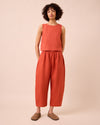 model wears mabel burnt orange linen trousers left