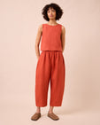 model wears mabel burnt orange linen trousers left
