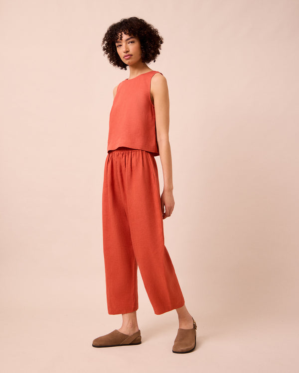 model wears mabel burnt orange linen trousers right