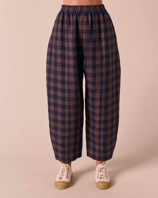 model wears mabel cedar check linen trousers front
