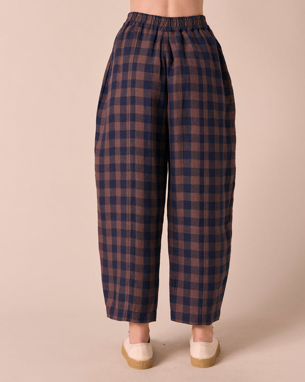 model wears mabel cedar check linen trousers back