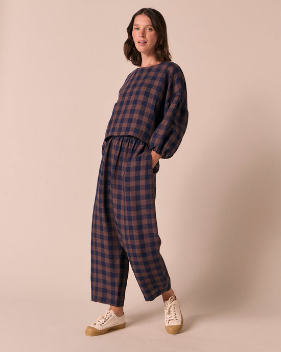 model wears mabel cedar check linen trousers right