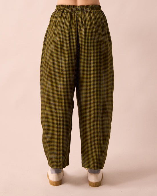 model wears mabel fresh olive mini gingham linen trousers back