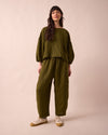 model wears mabel fresh olive mini gingham linen trousers left