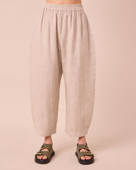 model wears mabel natural linen trousers front