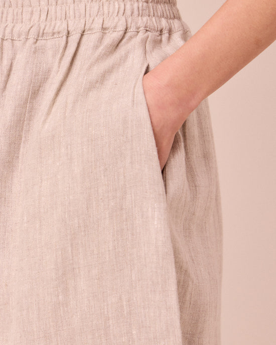 model wears mabel natural linen trousers
