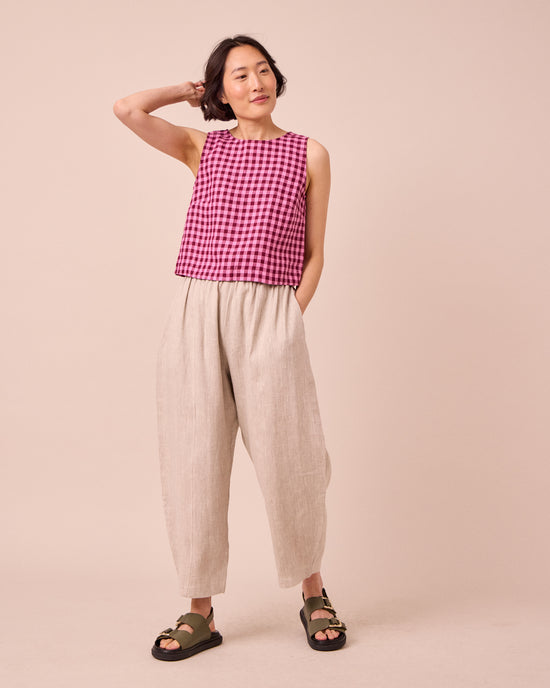 model wears mabel natural linen trousers left