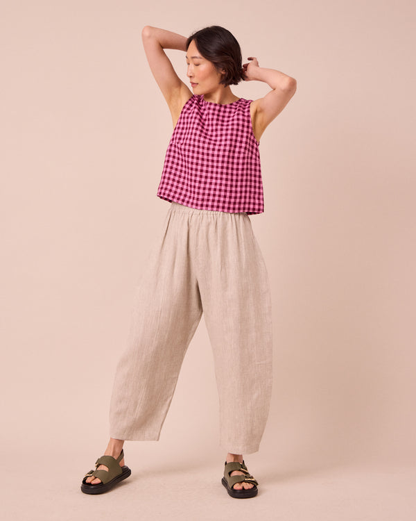 model wears mabel natural linen trousers right