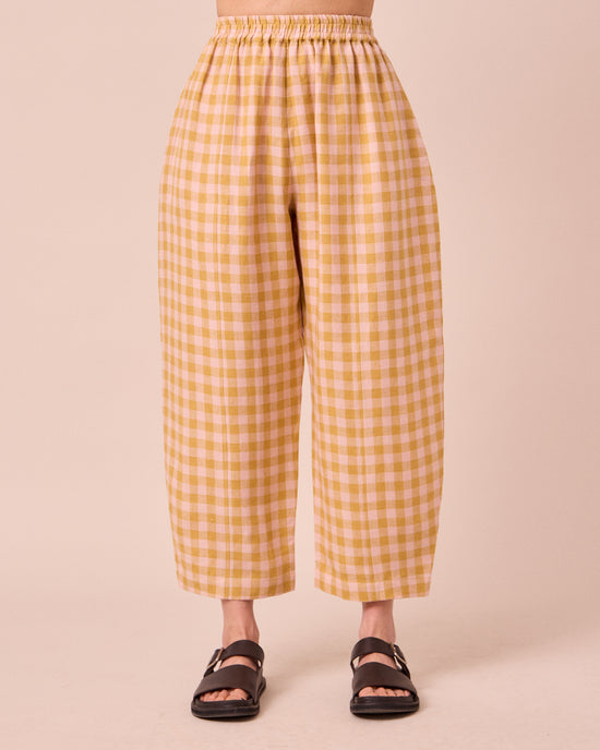 model wears mabel ochre gingham linen trousers front