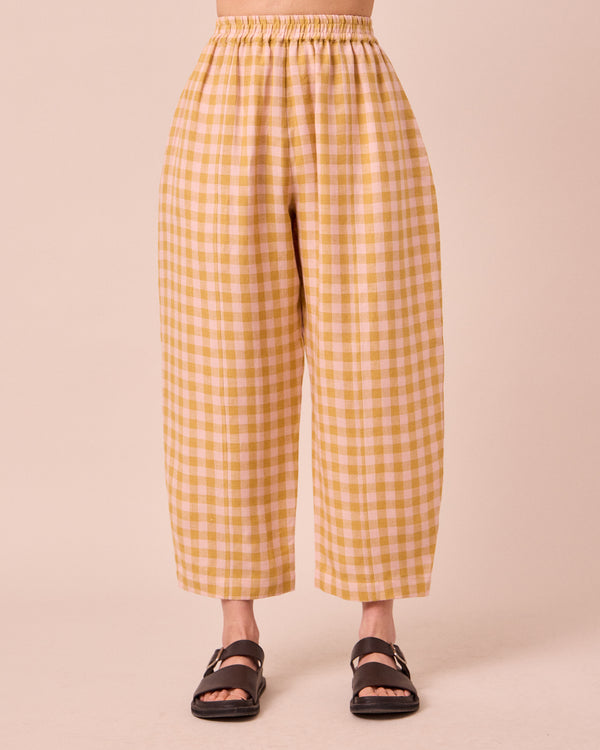model wears mabel ochre gingham linen trousers front