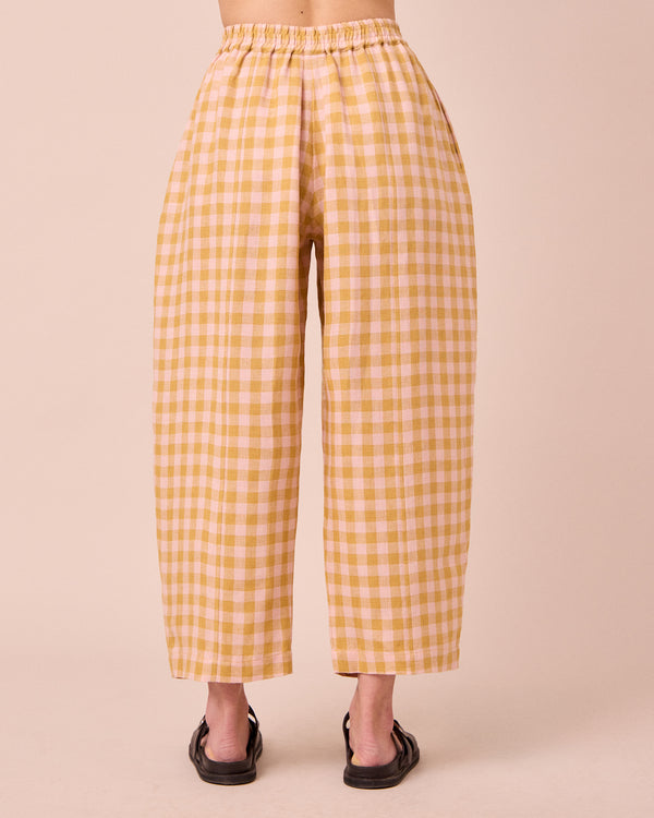 model wears mabel ochre gingham linen trousers back