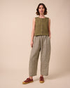 model wears mabel olive gingham linen trousers left