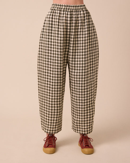 model wears mabel olive gingham linen trousers front