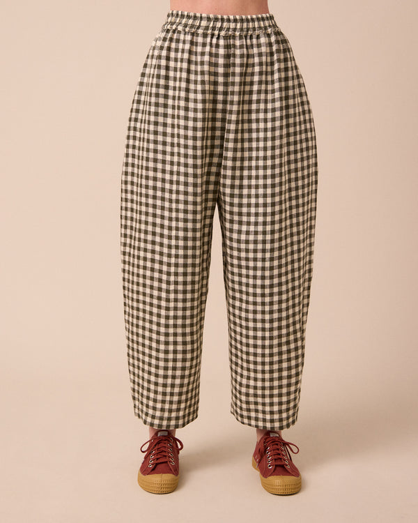 model wears mabel olive gingham linen trousers front