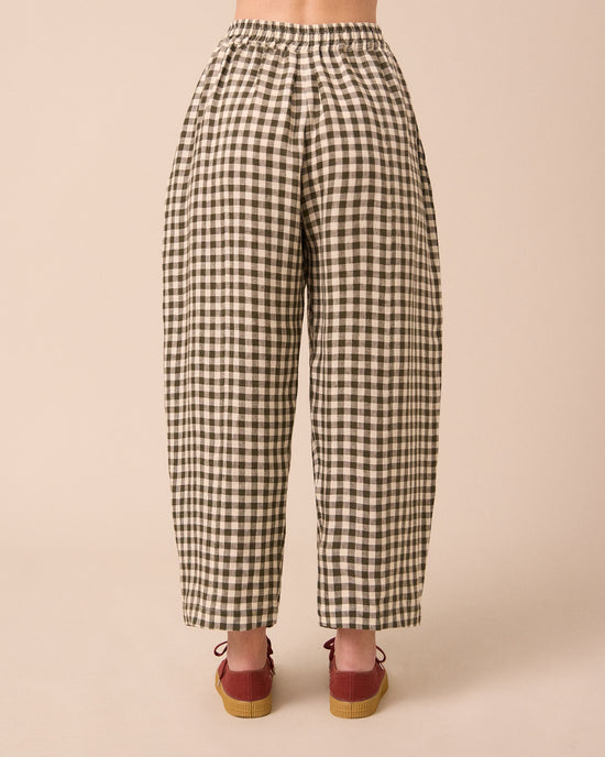 model wears mabel olive gingham linen trousers back