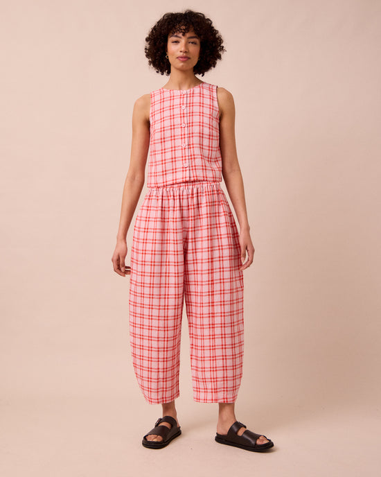 model wears mabel rosa plaid linen trousers left