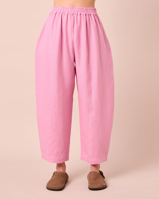 model wears mabel rose pink linen trousers front