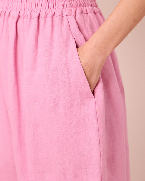model wears mabel rose pink linen trousers