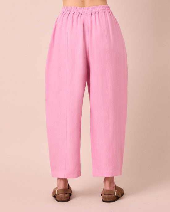 model wears mabel rose pink linen trousers back