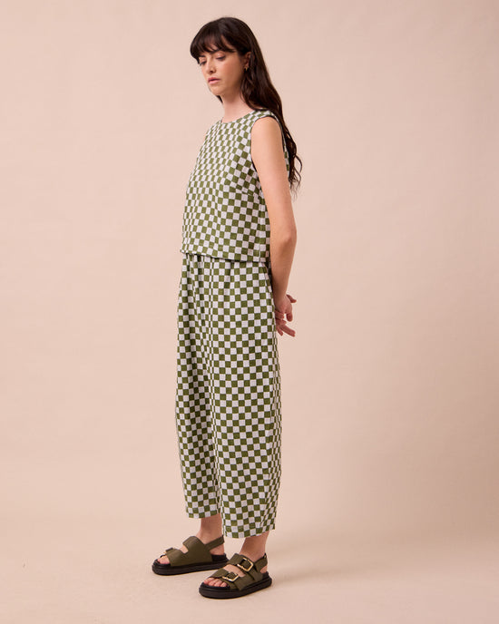 model wears mabel sky checkerboard linen trousers left