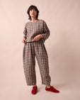 model wears mabel stone gingham linen trousers left