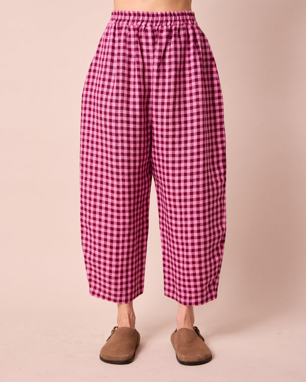 model wears mabel summer berry gingham linen trousers front
