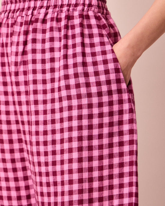 model wears mabel summer berry gingham linen trousers