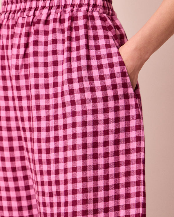model wears mabel summer berry gingham linen trousers