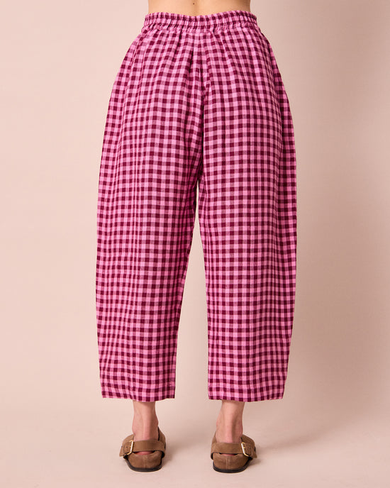 model wears mabel summer berry gingham linen trousers back