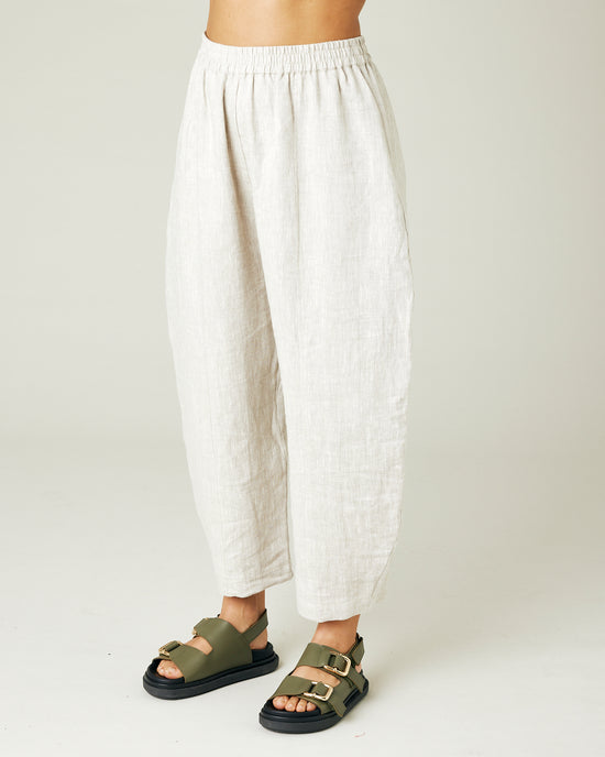 model wears natural linen mabel trousers from the left side