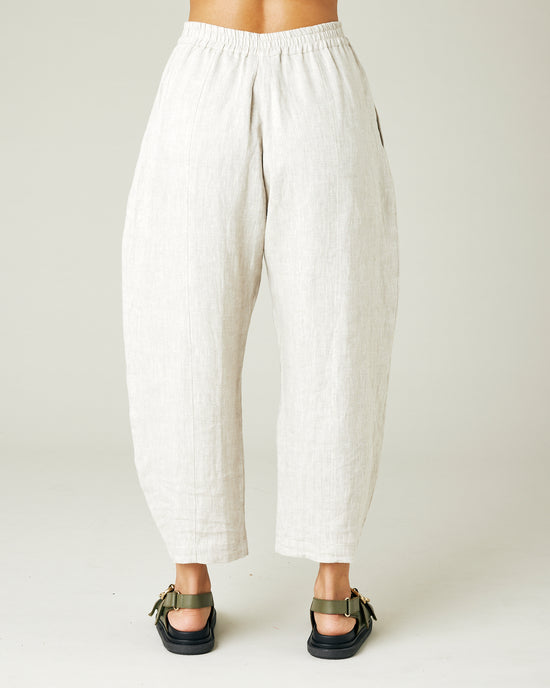 model wears natural linen mabel trousers from the back