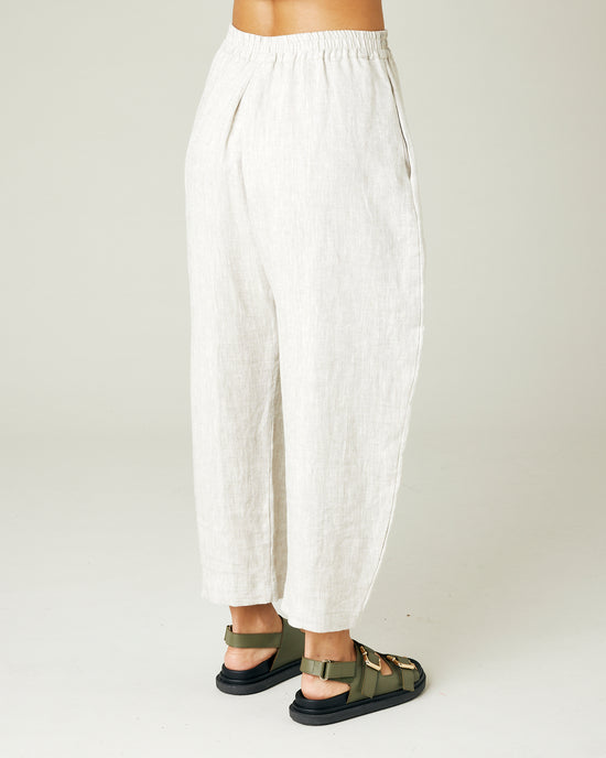 model wears natural linen mabel trousers from the right