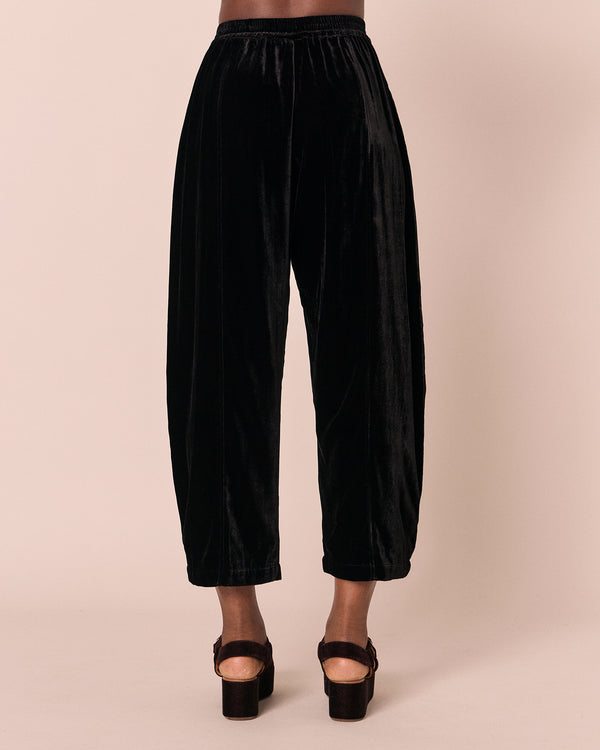 model wears mabel black velvet trousers back