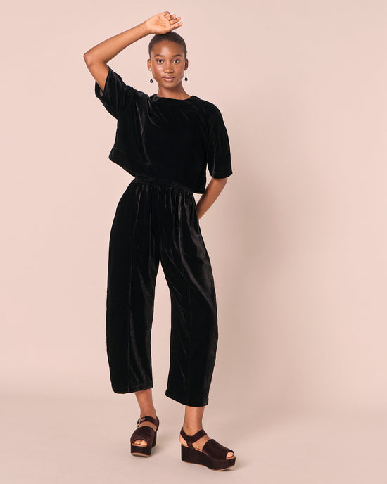 model wears mabel black velvet trousers right