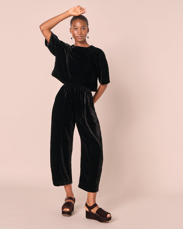 model wears mabel black velvet trousers right
